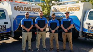 The Evolution Plumbing team in front of their service vans